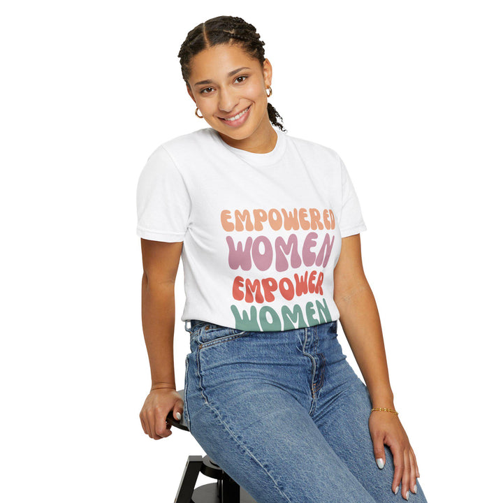 May include: White t-shirt with the text 'EMPOWERED WOMEN EMPOWER WOMEN' in a rainbow color scheme.
